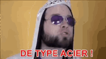 a man with a beard wearing sunglasses and a crown says de type acier