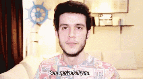 a man with a beard is wearing a colorful shirt that says ben gerzekallym