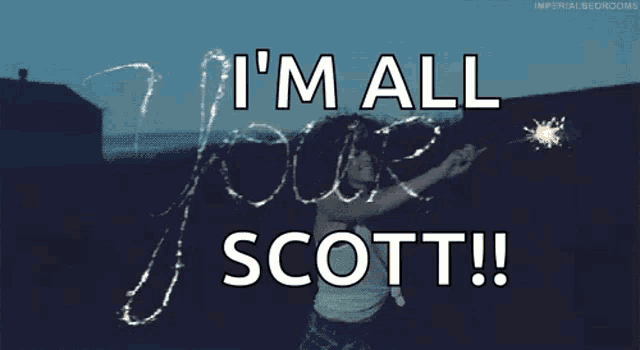 a woman is holding a sparkler in front of a sign that says i 'm all love scott