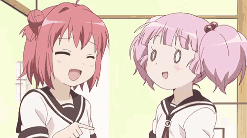two pink haired anime girls are standing next to each other .