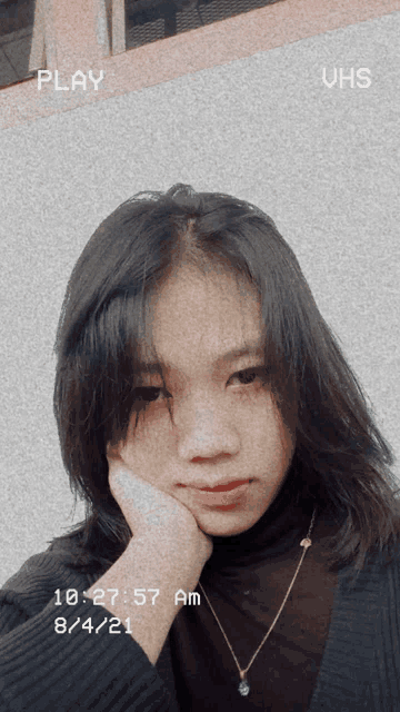 a girl 's face is shown with the time of 10:27 am on the bottom