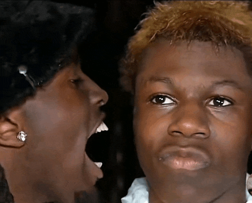 a close up of a person making a funny face with their mouth open