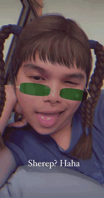 a girl with pigtails and green sunglasses has the word sherep on her face