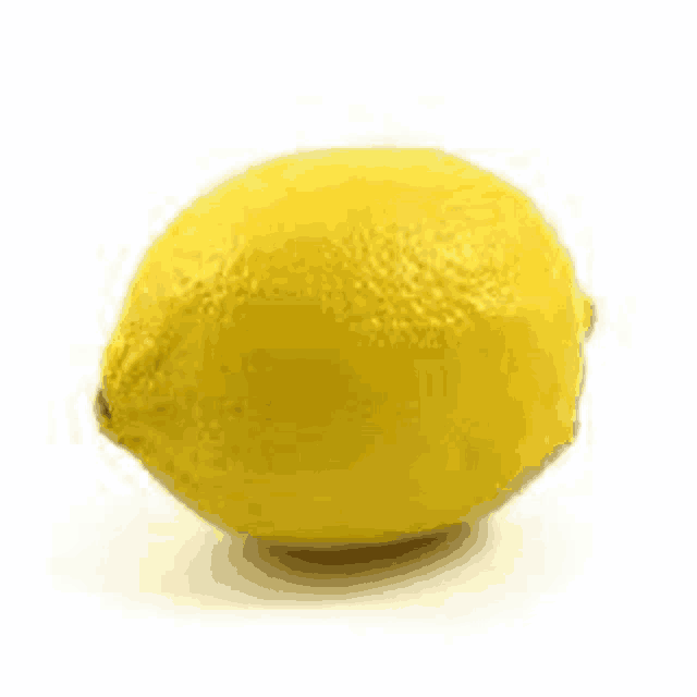 a single yellow lemon is sitting on a white surface .