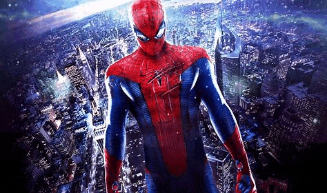 a man in a spiderman costume is standing in the middle of a city .