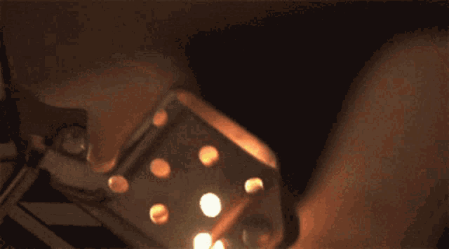a close up of a person lighting a zippo lighter with sparks coming out of it