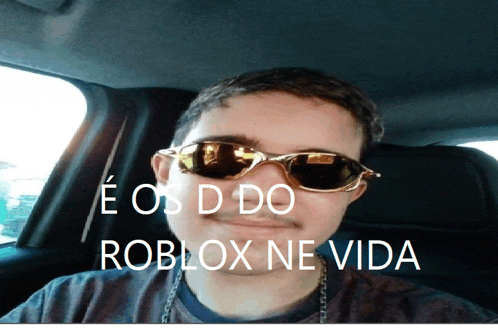 a man wearing sunglasses is sitting in a car with the words roblox ne vida above him