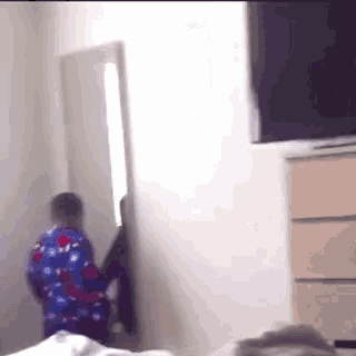 a person standing in front of a mirror in a bedroom