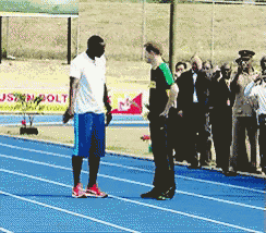 a man standing on a track with a sign that says jsn bolt