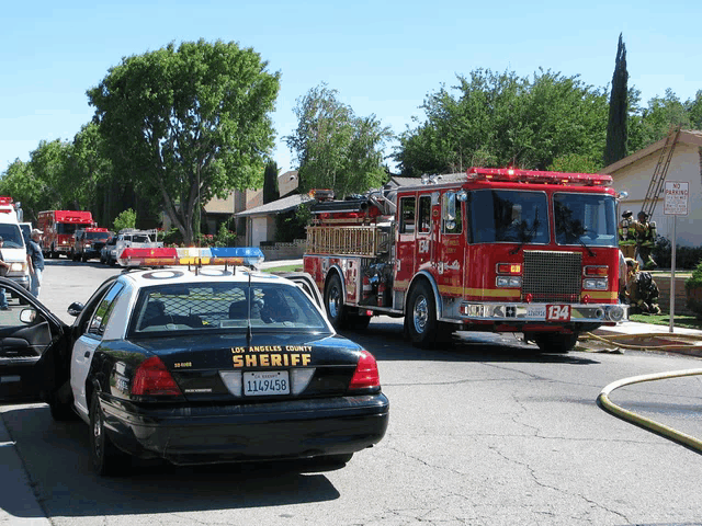 a los angeles county sheriff 's car is parked on the side of the road