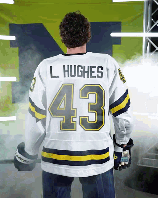 a hockey player named l. hughes wears a white jersey with the number 43 on it