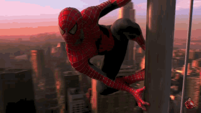 a man in a spiderman costume is hanging from a rope