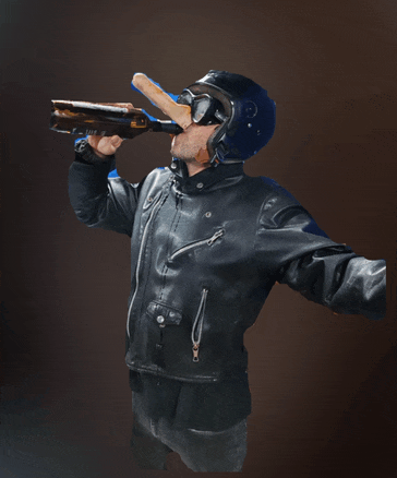 a man wearing a helmet and a leather jacket is drinking from a bottle of beer