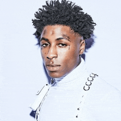 a young man with dreadlocks and a tattoo on his face is wearing a white jacket with the word gucci on it .