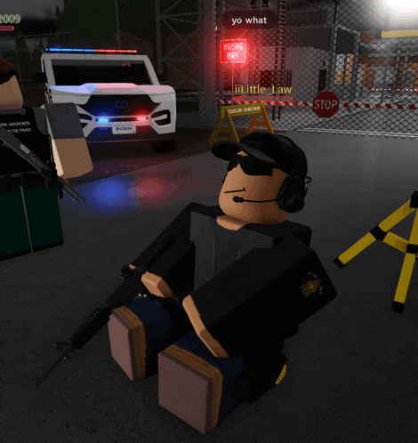 a video game character sitting in front of a police car and a sign that says " yo what "