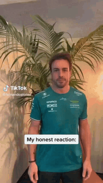 a man in a green shirt stands in front of a palm tree and says his honest reaction .