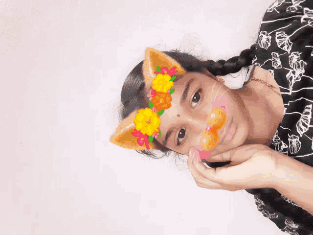 a girl wearing a cat ear mask with flowers on her face