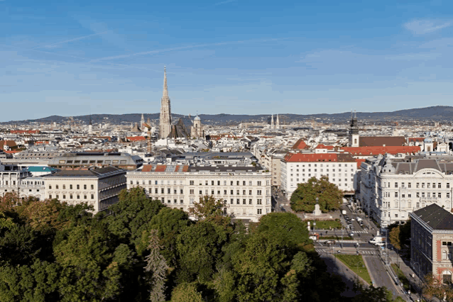 an aerial view of a city with a tower in the background