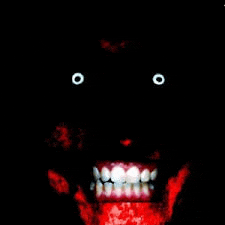 a close up of a person 's face with glowing eyes and a red mouth .