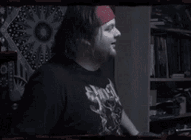 a man wearing a black shirt that says ' slayer ' on it