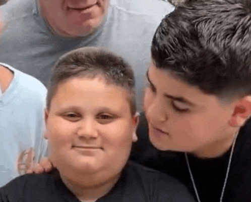 a group of young boys are posing for a picture with a man .