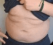 a close up of a person 's stomach with their shirt off .