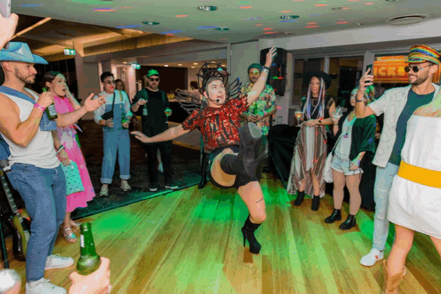 a group of people are dancing in front of a sign that says " cricket "