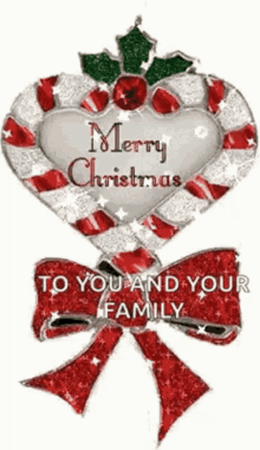 a christmas ornament in the shape of a heart with the words `` merry christmas to you and your family '' .