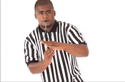 a referee in a black and white striped shirt with a whistle around his neck