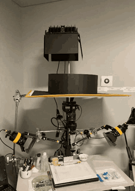 a camera is sitting on top of a table with a black box on top