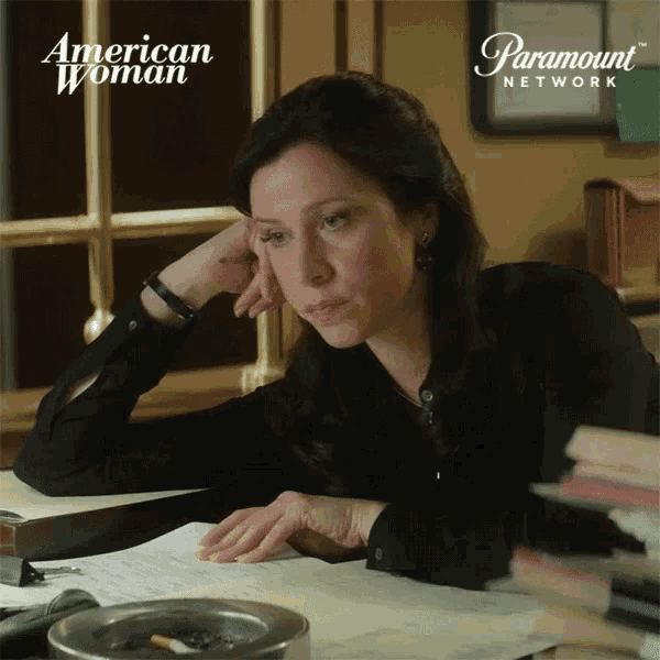 a woman sits at a desk with a paramount network logo on the bottom