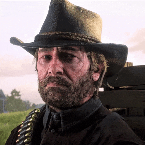 a man with a beard wears a cowboy hat and a bullet belt