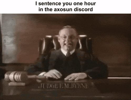 a black and white photo of a judge sitting at a desk with a gavel in front of him .