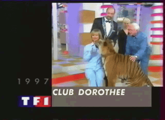 a group of people standing next to a tiger and a sign that says club dorothye
