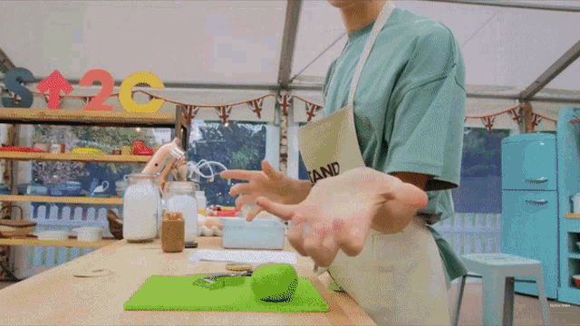 a person wearing an apron that says tan pro