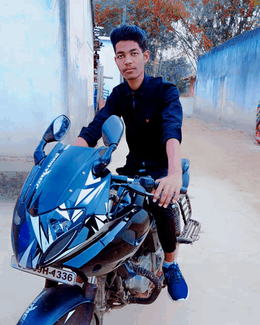 a young man is sitting on a motorcycle with a license plate that says 9h-4331