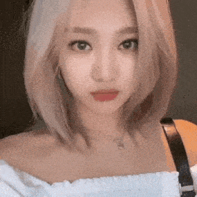 a close up of a woman 's face with blonde hair and red lips .