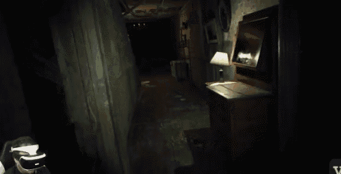 a person holding a flashlight in a dark room