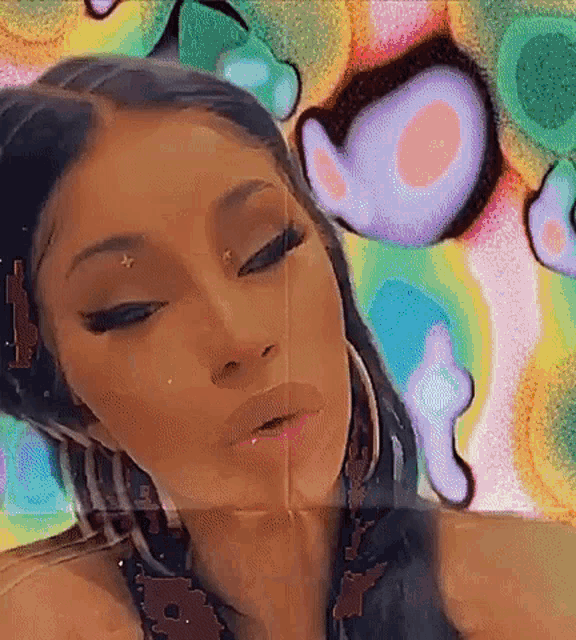 a close up of a woman 's face with a colorful background