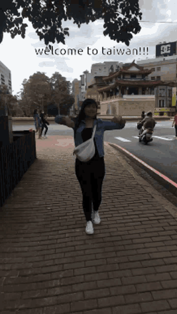 a woman stands on a brick sidewalk with her arms outstretched and the words welcome to taiwan written below her