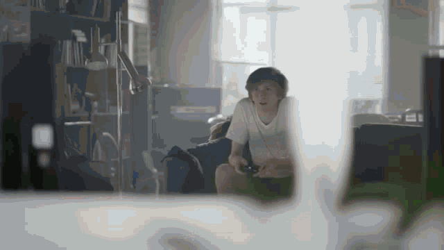 a boy playing a video game with a controller