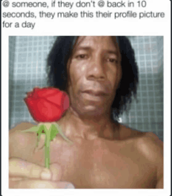 a shirtless man is holding a rose in his hand