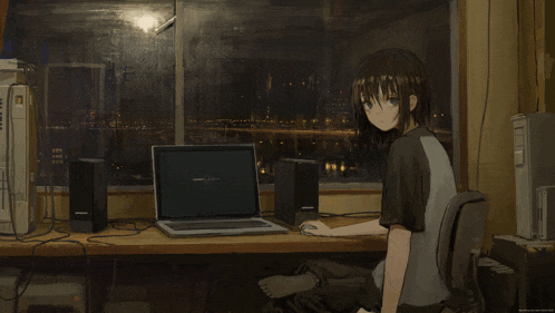 a girl sits at a desk with a laptop that says windows xp on the screen