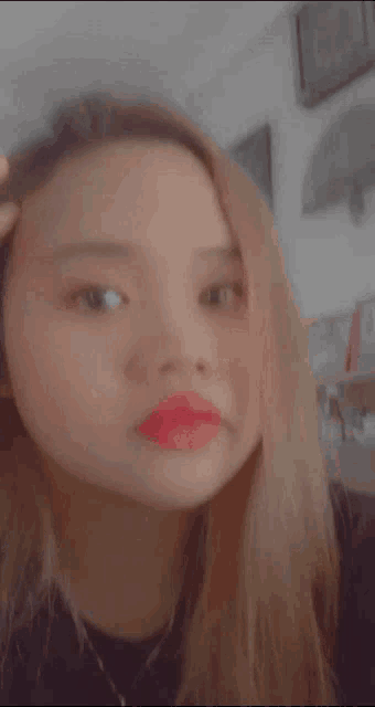 a close up of a woman 's face with red lipstick on