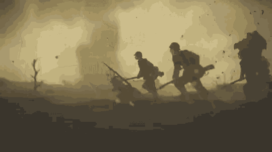 a group of soldiers are walking through a field holding guns in a war scene .