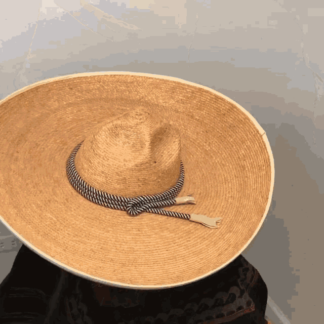 a large straw hat with a rope around the brim