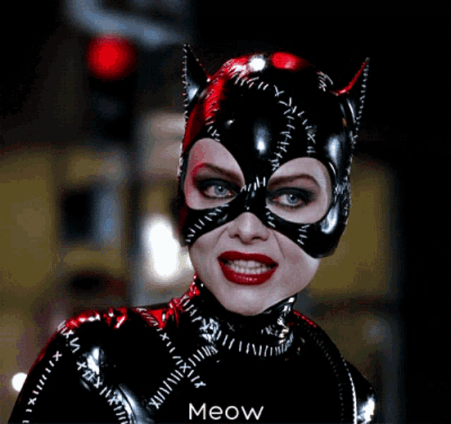 a woman in a catsuit with the word meow on the bottom right