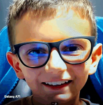 a young boy wearing glasses and a galaxy a71 behind him