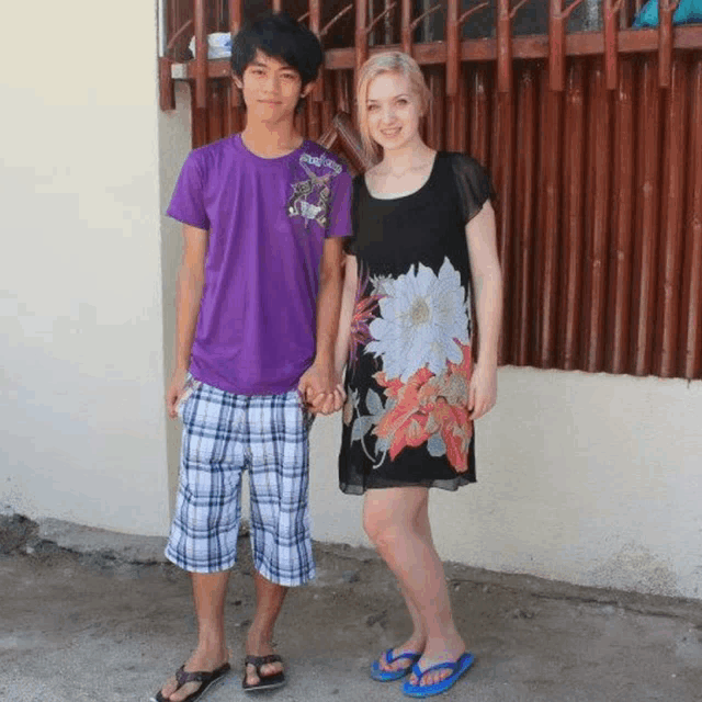 a man in a purple shirt and a woman in a black dress hold hands