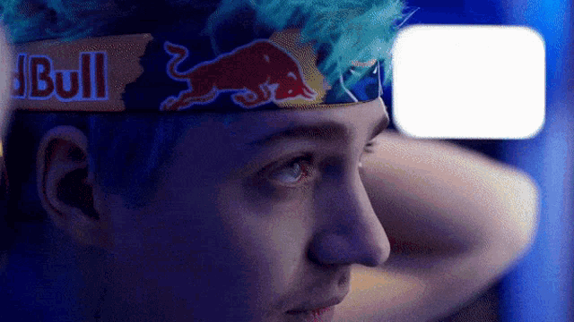 a man wearing a headband that says red bull
